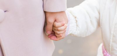 Child holding mother's hand. Mother's love in the hand, on the palm